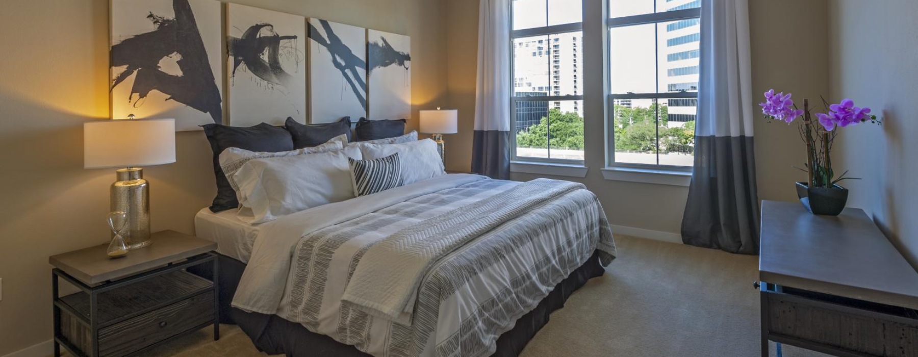 a bedroom with a bed and large window