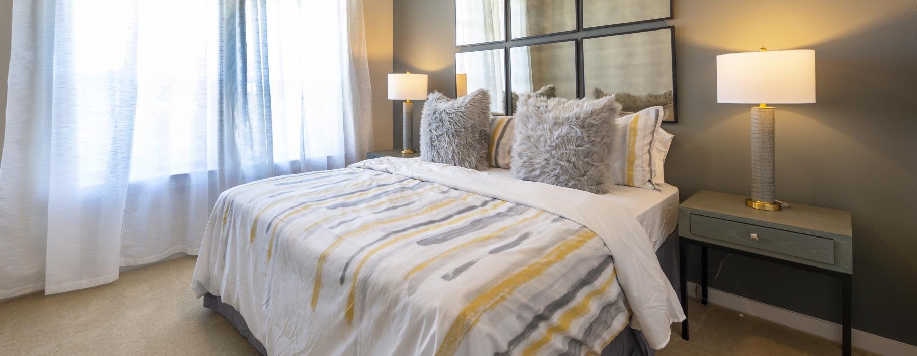 a bedroom with a bed and a large window